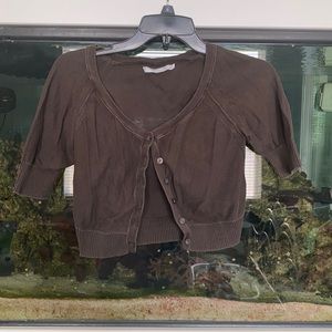 Small brown short sleeve cardigan.